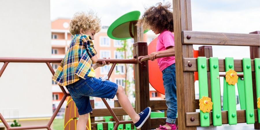curly-multiethnic-little-children-climbing-and-having-fun